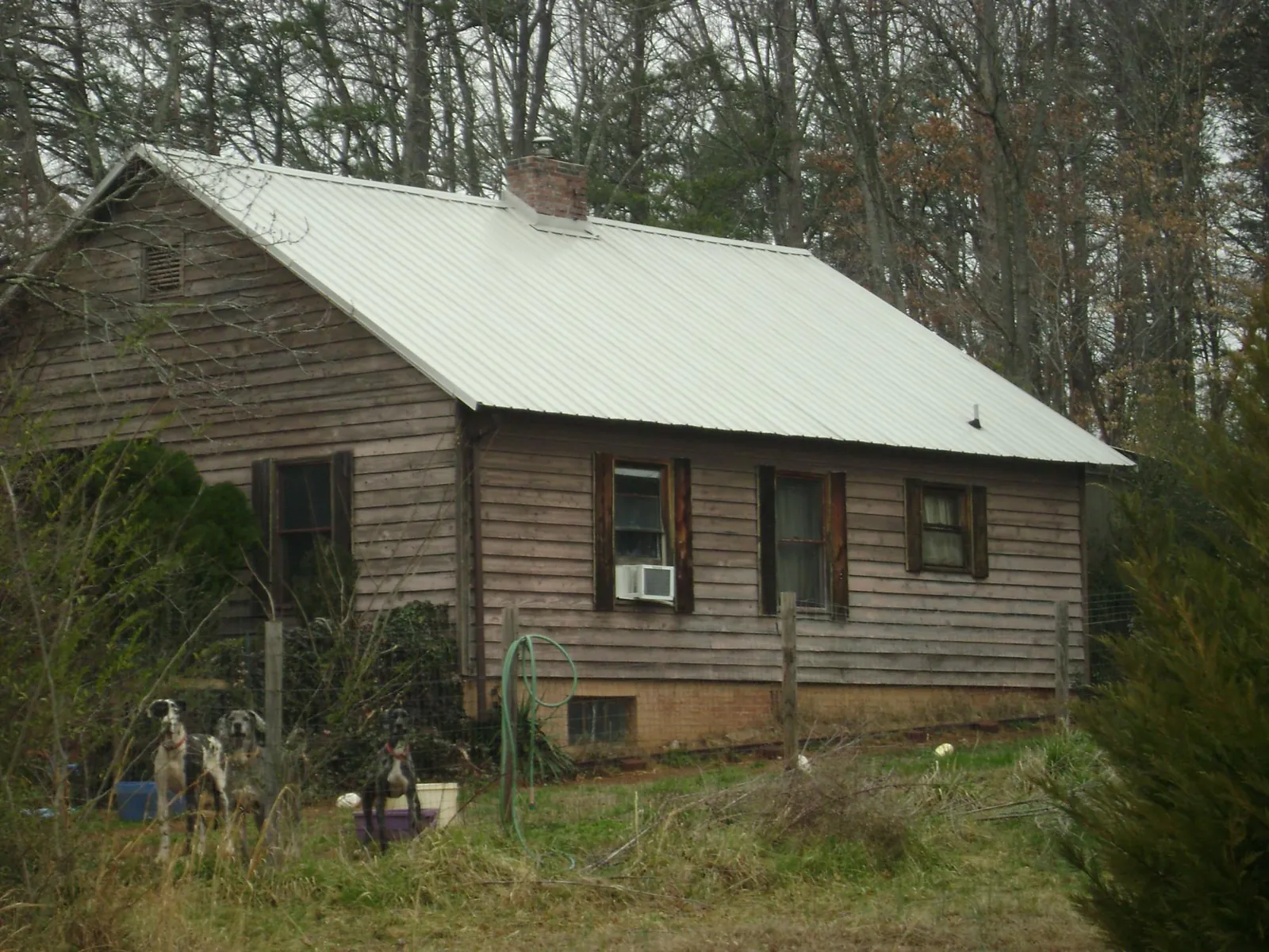 White metal roof on an old wood sided farmhouse, from a Metal Roof Installation job in Berwick